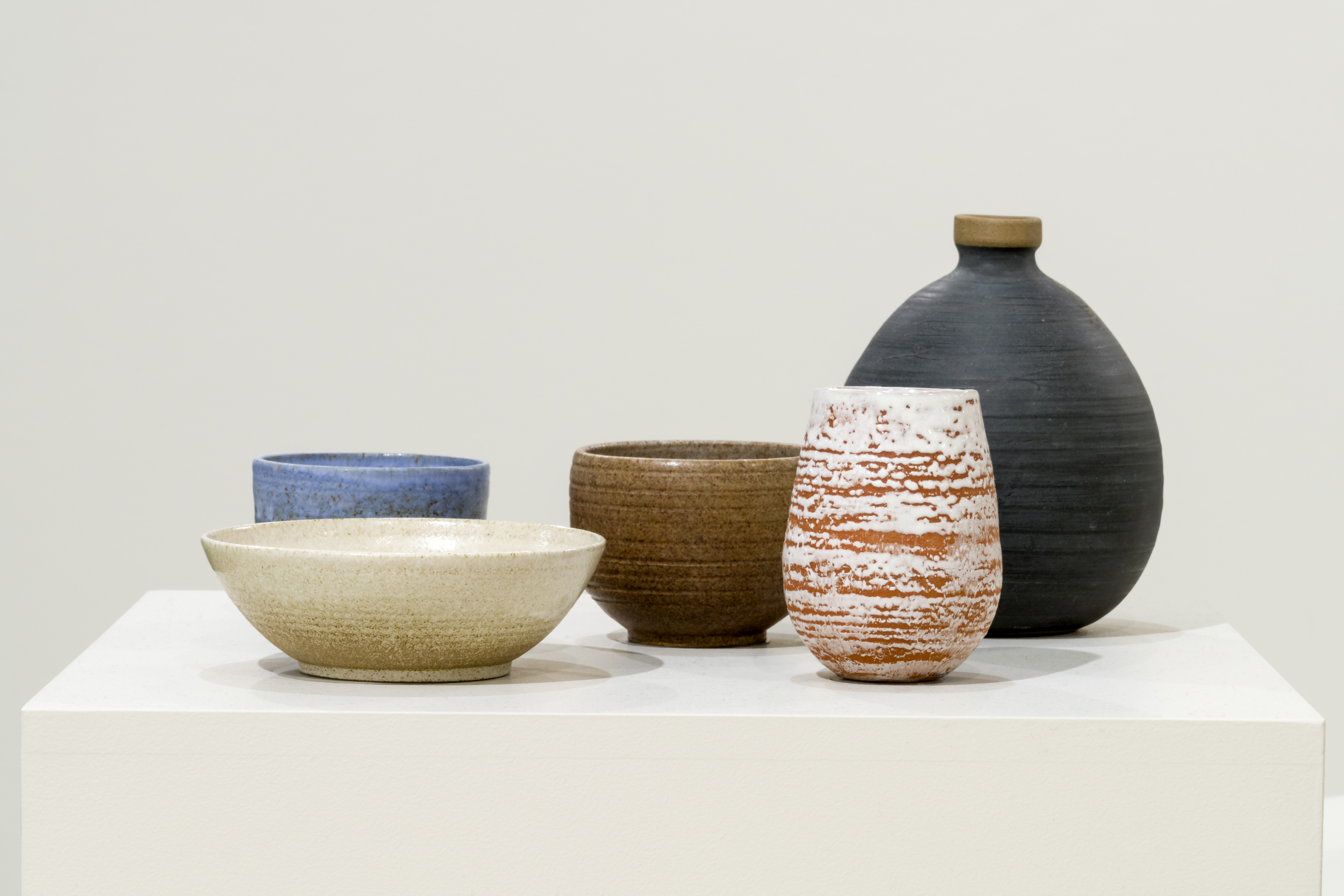 Closeup of ceramic bowls and vases.