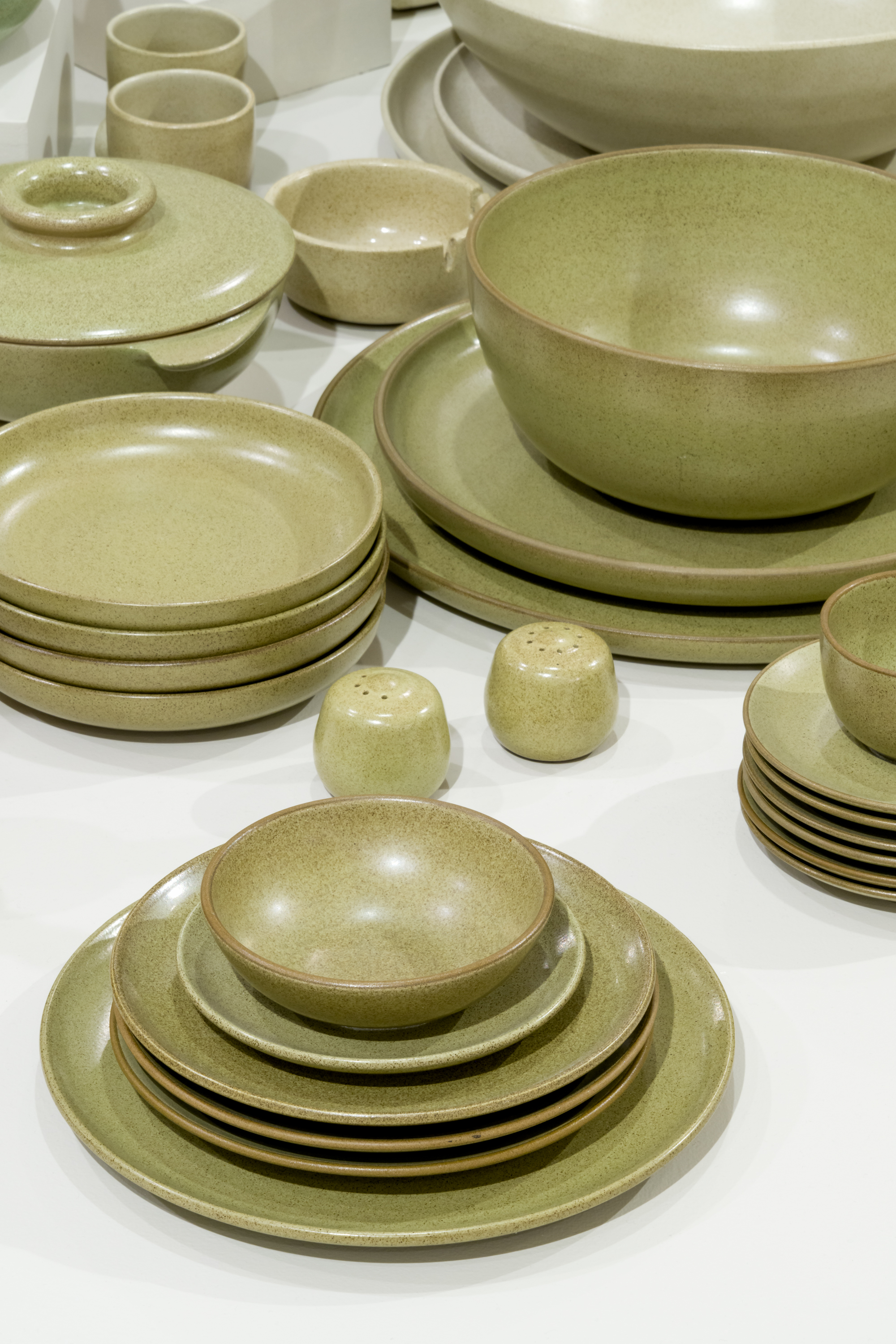 salt and pepper shakers, plates and bowls in light green glaze.
