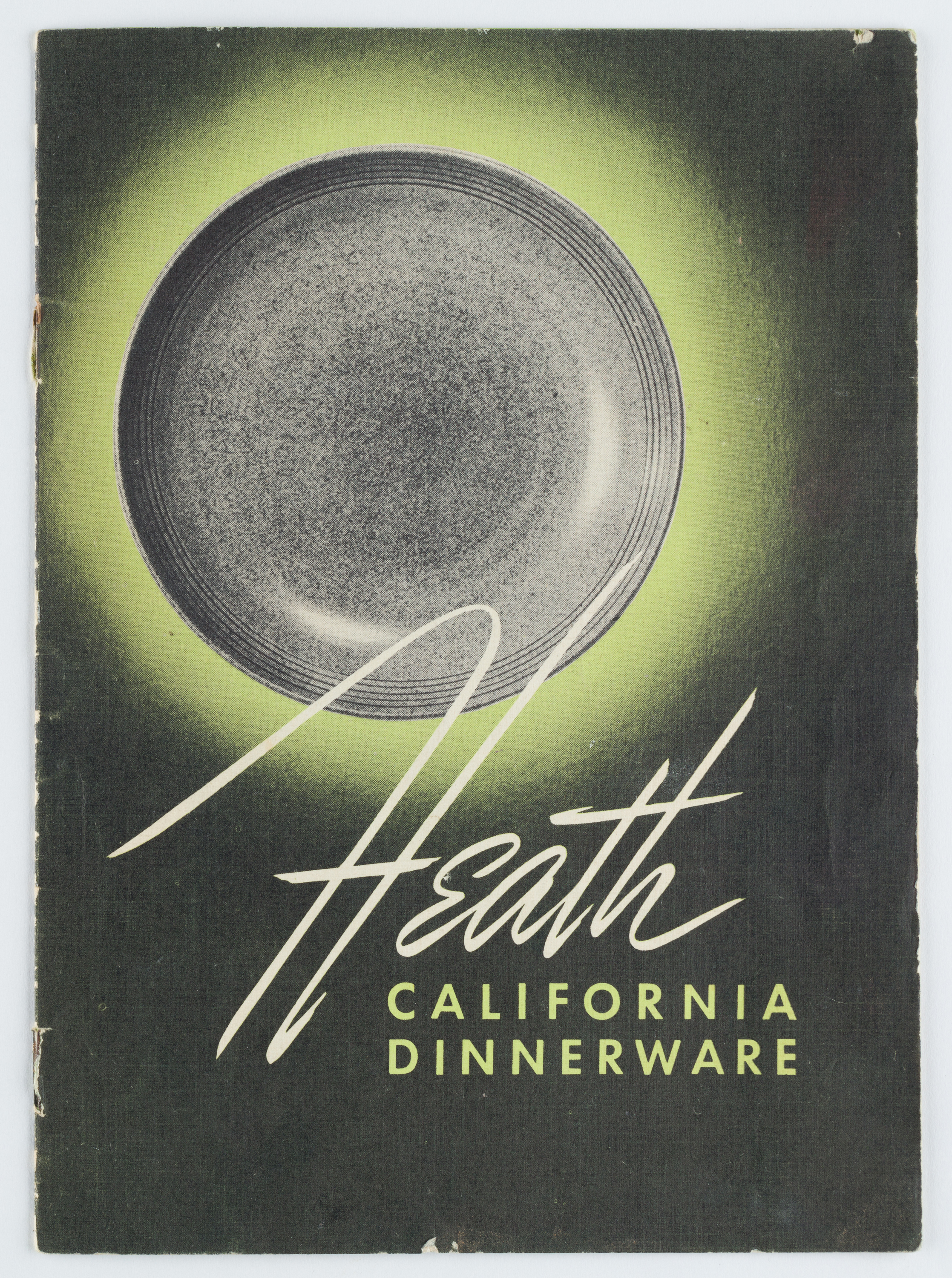 Cover of a sales brochure with black backgorund, black and white image of a ceramic plate with a green halo around and white and green letters.