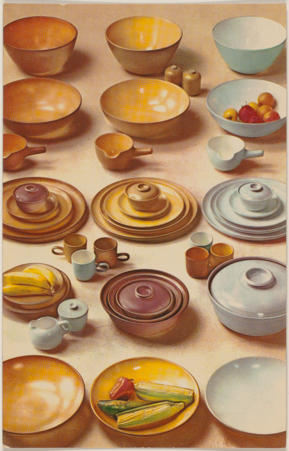 Plates, bowls, cups and other Heath dinnerware in yellow, purple and blue tones, with decorative fruits.